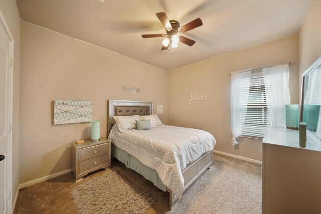 3225 Summer Tanager Ln, Manvel, TX 77578 - bedroom featuring light carpet, baseboards, and a ceiling fan