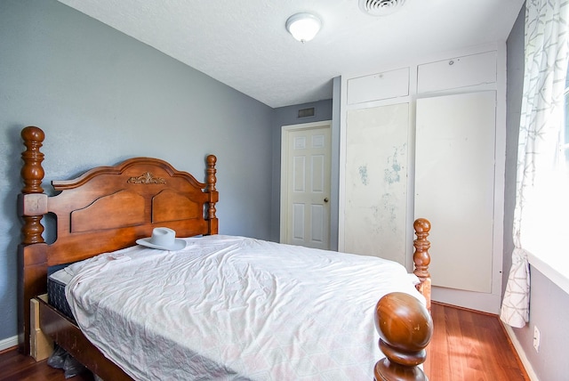 1905 Tennessee St, Baytown, TX 77520 - bedroom with wood finished floors, lofted ceiling, and visible vents