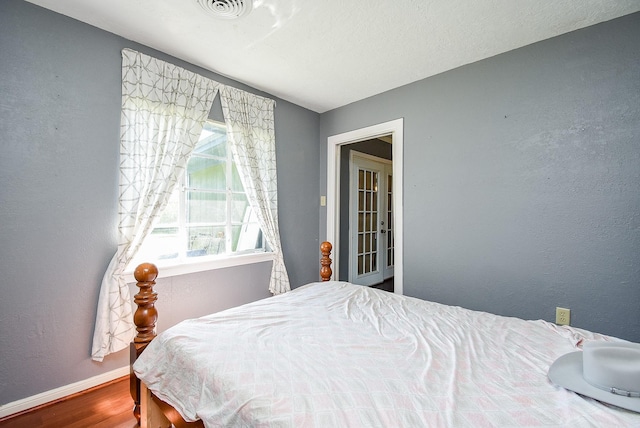 1905 Tennessee St, Baytown, TX 77520 - bedroom with visible vents, baseboards, and wood finished floors