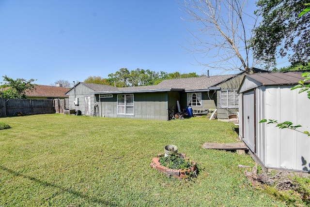 1905 Tennessee St, Baytown, TX 77520 - back of property with an outdoor structure, fence, a lawn, and a storage unit