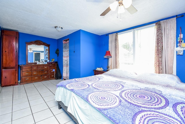 1905 Tennessee St, Baytown, TX 77520 - bedroom featuring tile patterned floors, a ceiling fan, and a textured ceiling