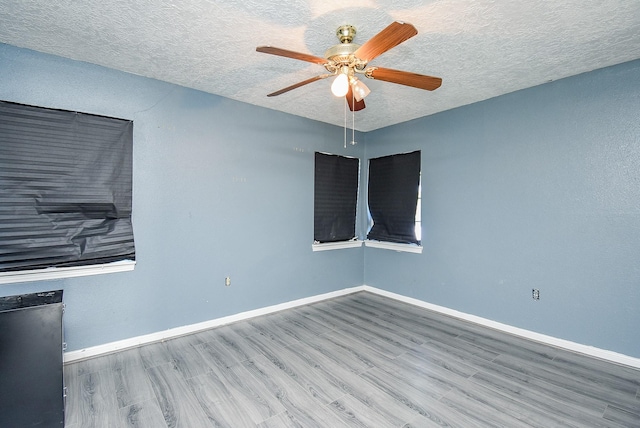 1905 Tennessee St, Baytown, TX 77520 - empty room featuring baseboards, ceiling fan, wood finished floors, and a textured ceiling