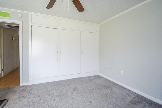 1905 Tennessee St, Baytown, TX 77520 - unfurnished bedroom with ornamental molding, carpet flooring, and a textured ceiling