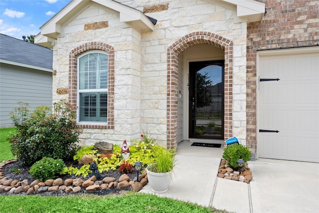 1143 Grand Junction Dr, Tomball, TX 77375 - entrance to property with an attached garage, brick siding, and stone siding