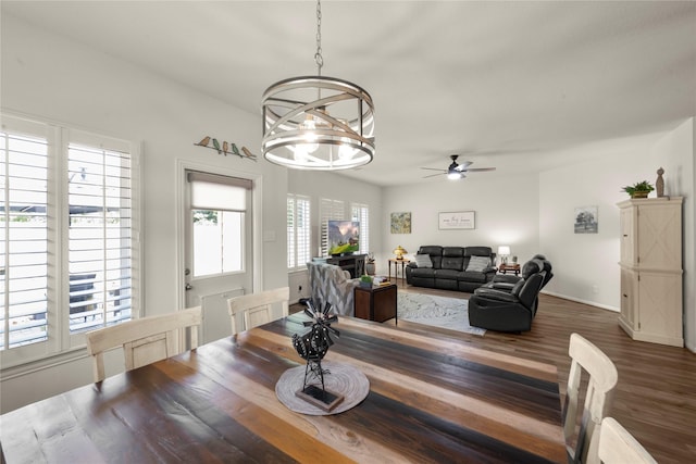 1143 Grand Junction Dr, Tomball, TX 77375 - dining space featuring wood finished floors, baseboards, and ceiling fan with notable chandelier