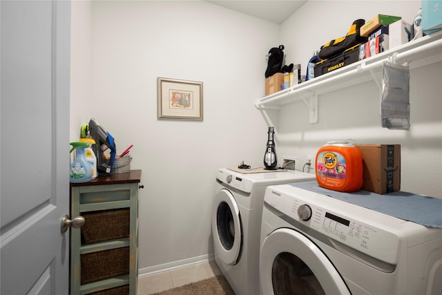 1143 Grand Junction Dr, Tomball, TX 77375 - clothes washing area with baseboards, washer and clothes dryer, laundry area, and light tile patterned floors