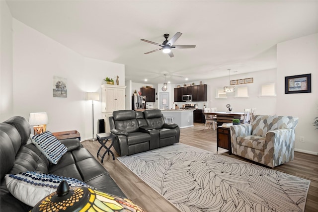 1143 Grand Junction Dr, Tomball, TX 77375 - living area featuring ceiling fan, baseboards, and light wood-style floors