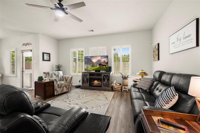 1143 Grand Junction Dr, Tomball, TX 77375 - living area with a ceiling fan, wood finished floors, visible vents, and plenty of natural light