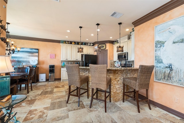 206 China Clipper Dr, Freeport, TX 77541 - kitchen featuring light stone countertops, a peninsula, visible vents, black refrigerator with ice dispenser, and stainless steel microwave
