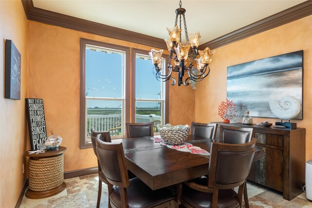 206 China Clipper Dr, Freeport, TX 77541 - dining space featuring ornamental molding, baseboards, stone finish floor, and a chandelier