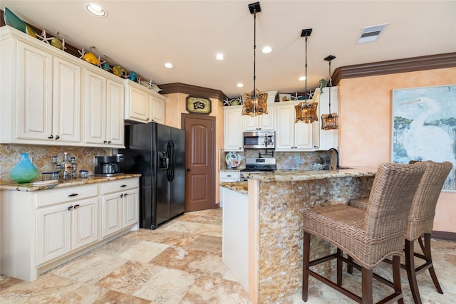 206 China Clipper Dr, Freeport, TX 77541 - kitchen featuring tasteful backsplash, appliances with stainless steel finishes, a kitchen bar, a peninsula, and light stone counters