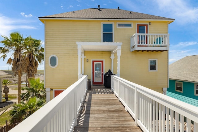206 China Clipper Dr, Freeport, TX 77541 - exterior space featuring a shingled roof and a balcony