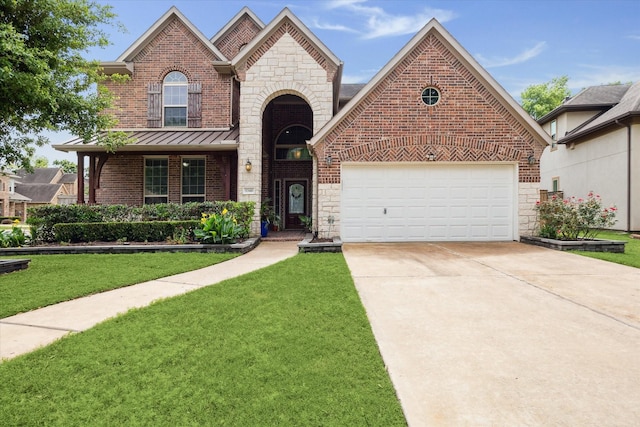 view of front of property featuring a front lawn, driveway, stone siding, brick siding, and an attached garage
