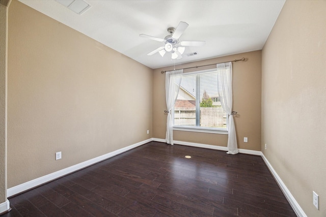 empty room featuring wood finished floors, visible vents, baseboards, and ceiling fan
