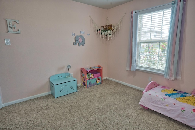 carpeted bedroom with multiple windows and baseboards