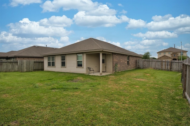 back of house with a yard, a patio, and a fenced backyard