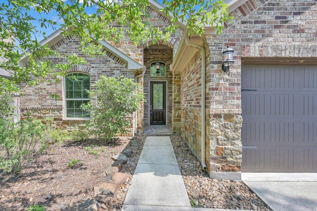 114 Winecup Cir, Montgomery, TX 77316 - view of exterior entry featuring a garage and stone siding