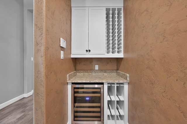 114 Winecup Cir, Montgomery, TX 77316 - bar featuring a textured wall, baseboards, wood finished floors, and wine cooler