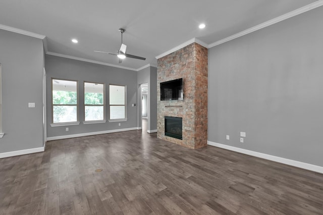 114 Winecup Cir, Montgomery, TX 77316 - unfurnished living room with baseboards, ornamental molding, a stone fireplace, a ceiling fan, and dark wood-style floors