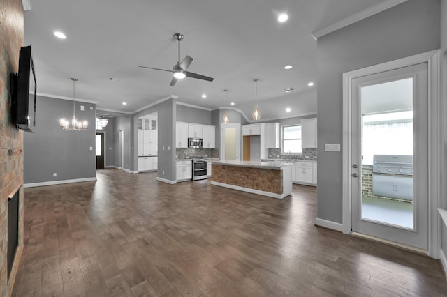 114 Winecup Cir, Montgomery, TX 77316 - kitchen featuring ornamental molding, open floor plan, backsplash, appliances with stainless steel finishes, and ceiling fan with notable chandelier