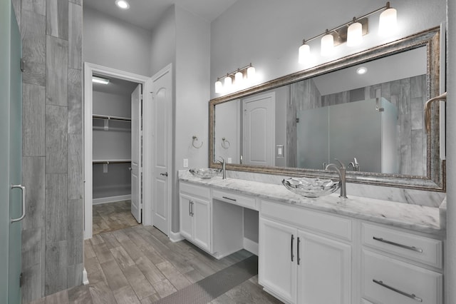 114 Winecup Cir, Montgomery, TX 77316 - full bath featuring tiled shower, double vanity, a sink, and a spacious closet