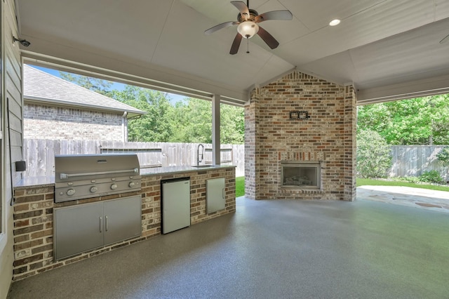114 Winecup Cir, Montgomery, TX 77316 - view of patio / terrace featuring fence, exterior kitchen, area for grilling, an outdoor brick fireplace, and ceiling fan