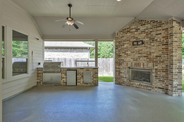 114 Winecup Cir, Montgomery, TX 77316 - view of patio / terrace with area for grilling, an outdoor brick fireplace, an outdoor kitchen, a ceiling fan, and fence
