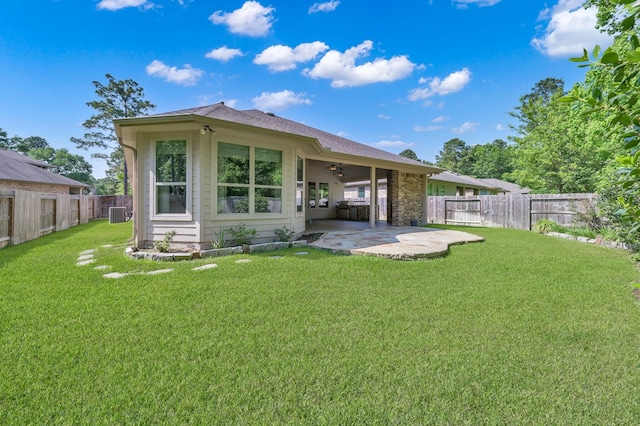 114 Winecup Cir, Montgomery, TX 77316 - back of house with a lawn, ceiling fan, a fenced backyard, and a patio area