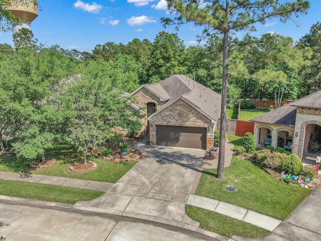 114 Winecup Cir, Montgomery, TX 77316 - view of front of home with a front lawn, driveway, a garage, brick siding, and roof with shingles