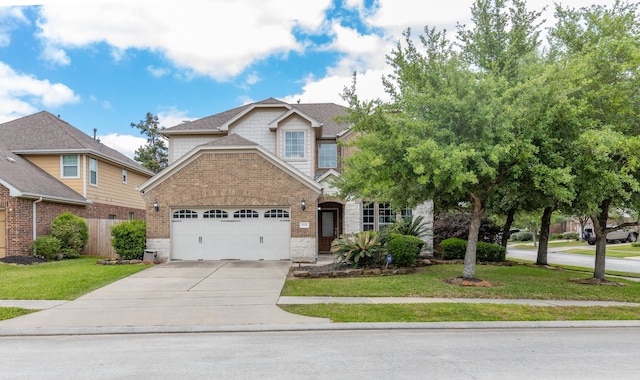 view of front of home with fence, stone siding, a front yard, concrete driveway, and an attached garage