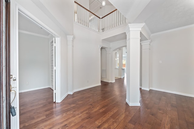 6214 Laguna Del Rey Dr, Houston, TX 77041 - entrance foyer with arched walkways, ornate columns, baseboards, and wood finished floors
