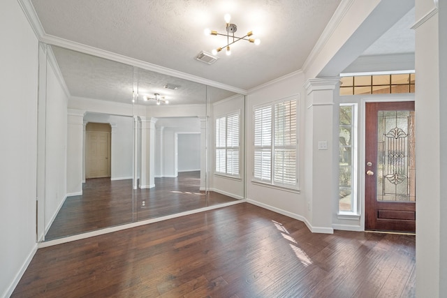 6214 Laguna Del Rey Dr, Houston, TX 77041 - entrance foyer featuring baseboards, an inviting chandelier, dark wood-style floors, visible vents, and ornate columns