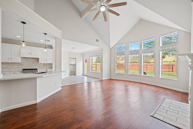 6214 Laguna Del Rey Dr, Houston, TX 77041 - unfurnished living room featuring visible vents, a sink, a ceiling fan, wood finished floors, and high vaulted ceiling