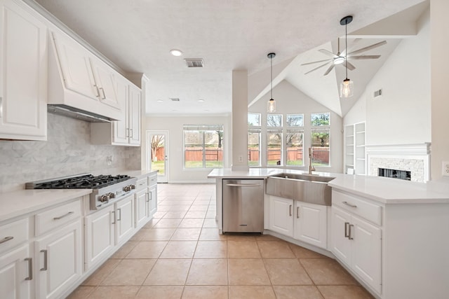 6214 Laguna Del Rey Dr, Houston, TX 77041 - kitchen with ceiling fan, a fireplace, backsplash, stainless steel dishwasher, and gas cooktop