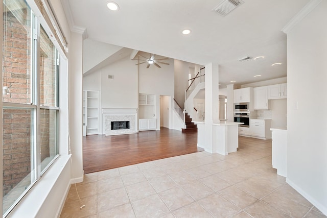 6214 Laguna Del Rey Dr, Houston, TX 77041 - unfurnished living room with visible vents, a ceiling fan, light tile patterned floors, and a fireplace