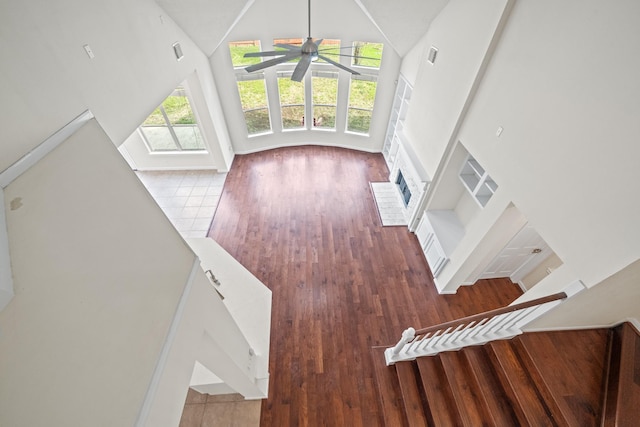 6214 Laguna Del Rey Dr, Houston, TX 77041 - unfurnished living room with high vaulted ceiling, wood finished floors, a fireplace, and a ceiling fan