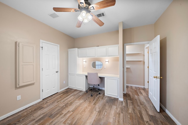 office space featuring visible vents, ceiling fan, wood finished floors, and baseboards