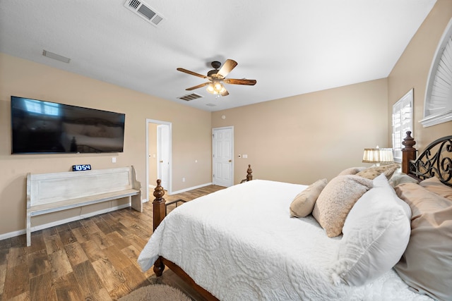bedroom featuring visible vents, baseboards, and wood finished floors