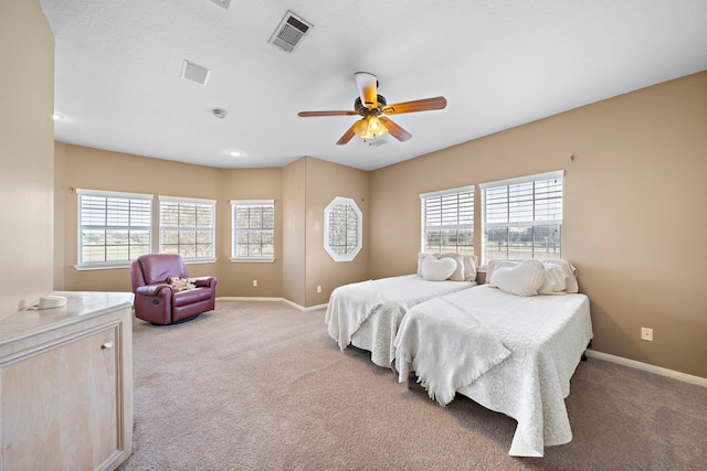 bedroom featuring visible vents, baseboards, and light colored carpet