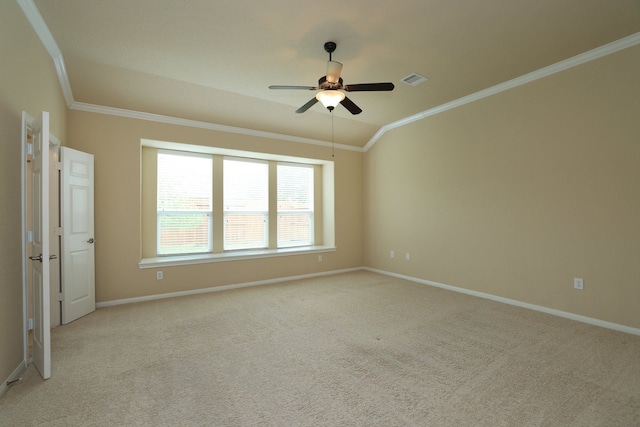 spare room with crown molding, ceiling fan, light colored carpet, and baseboards