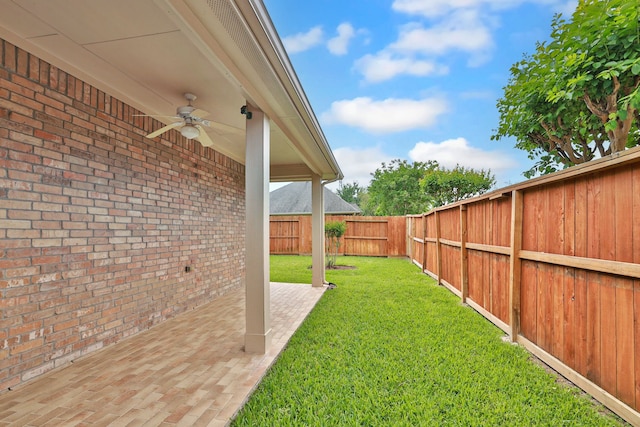 view of yard with a patio, a fenced backyard, and a ceiling fan