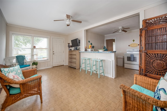 120 W Main St, Port O Connor, TX 77982 - sitting room featuring ceiling fan, crown molding, light flooring, and a decorative wall