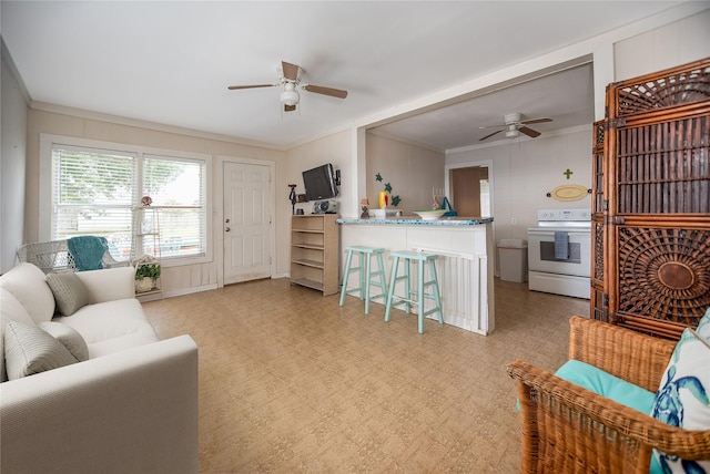 120 W Main St, Port O Connor, TX 77982 - living area with a ceiling fan, crown molding, a decorative wall, and light floors