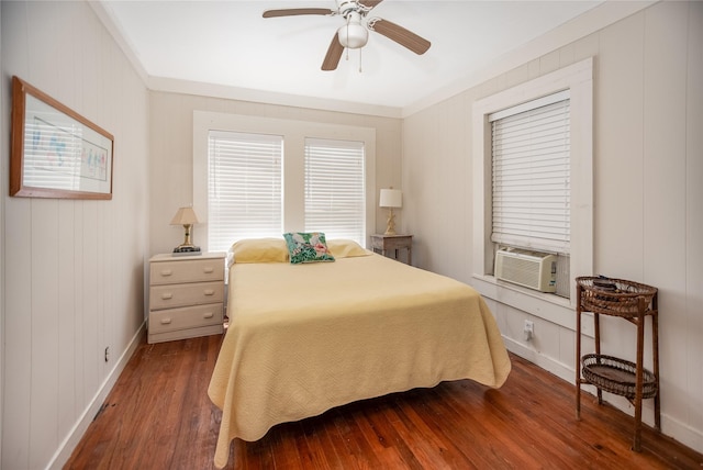 120 W Main St, Port O Connor, TX 77982 - bedroom featuring dark wood-style flooring, cooling unit, multiple windows, and a ceiling fan