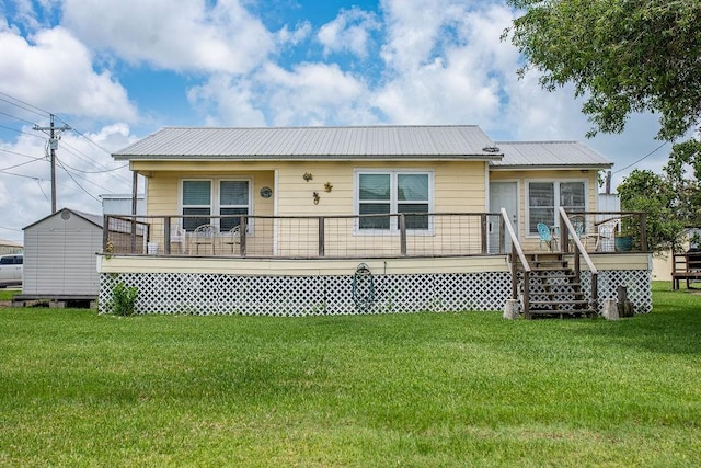 120 W Main St, Port O Connor, TX 77982 - back of house featuring a yard, a metal roof, and a wooden deck