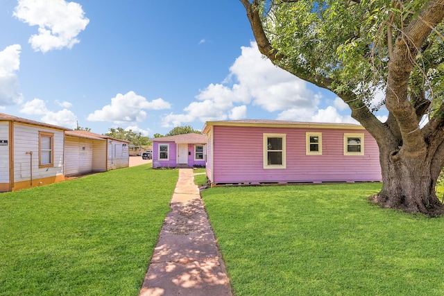 back of property featuring a lawn