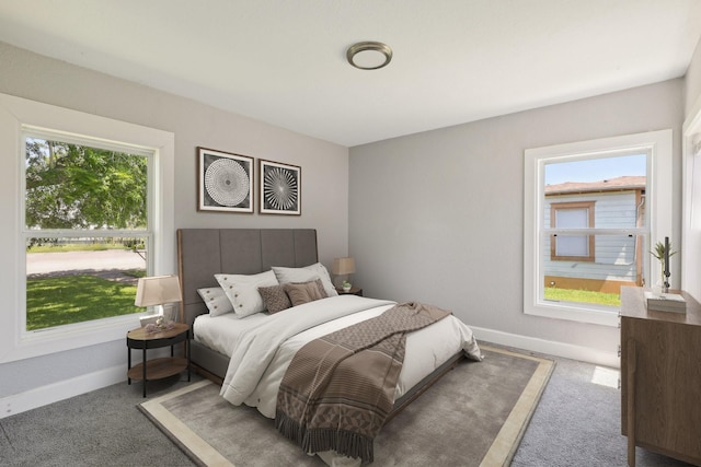 carpeted bedroom featuring baseboards