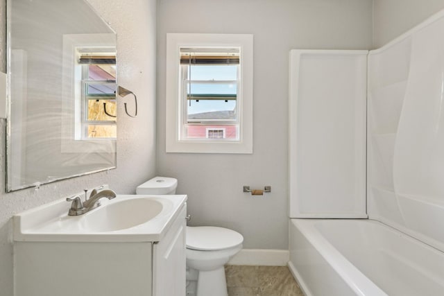 bathroom featuring toilet, vanity, tile patterned floors, and baseboards