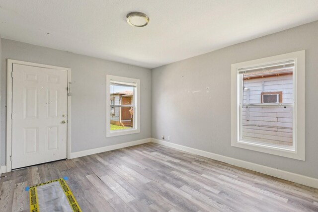 interior space with baseboards and wood finished floors