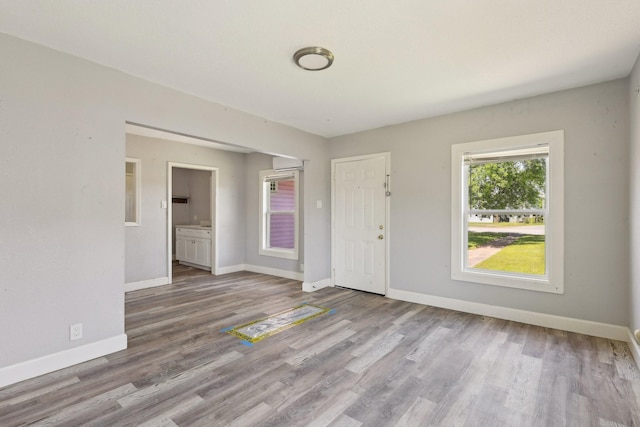 unfurnished room featuring baseboards and wood finished floors